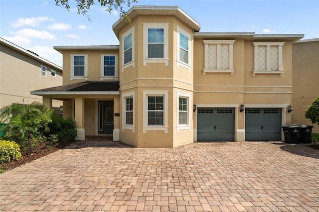 7616 Brookhurst Ln, Kissimmee, FL 34747 - townhome / multi-family property with stucco siding, decorative driveway, and a garage