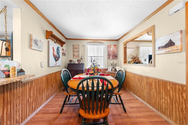 517 Carolina Ave, Saint Cloud, FL 34769 - dining area with a wainscoted wall, wood walls, wood finished floors, and ornamental molding