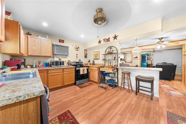 517 Carolina Ave, Saint Cloud, FL 34769 - kitchen featuring appliances with stainless steel finishes, ceiling fan, a sink, a peninsula, and light countertops