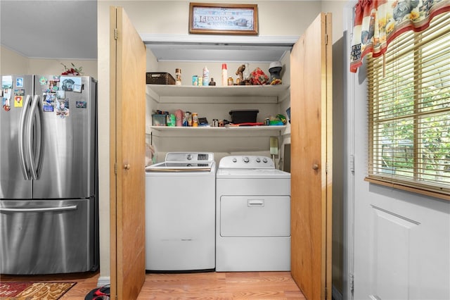 517 Carolina Ave, Saint Cloud, FL 34769 - laundry room featuring independent washer and dryer and light wood-type flooring