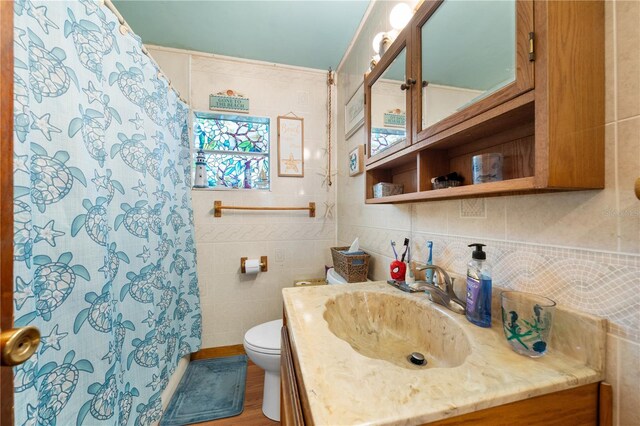 517 Carolina Ave, Saint Cloud, FL 34769 - bathroom featuring vanity, toilet, tile walls, a shower with shower curtain, and backsplash