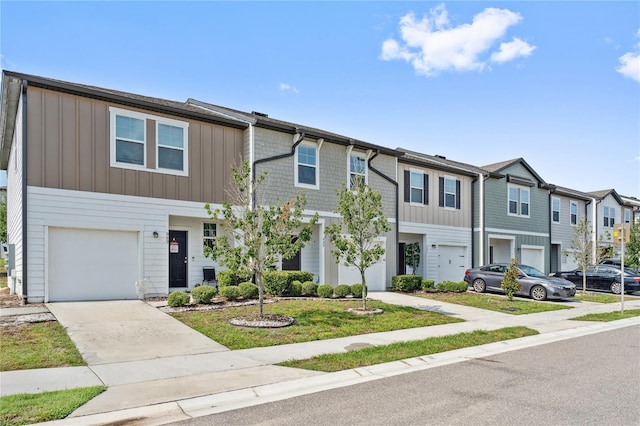 955 Grandin St, Davenport, FL 33837 - multi unit property featuring a garage, board and batten siding, a residential view, and concrete driveway