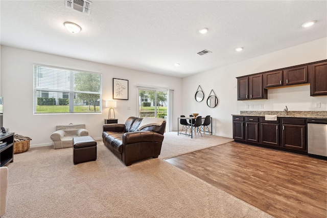 955 Grandin St, Davenport, FL 33837 - carpeted living room featuring wood finished floors, recessed lighting, baseboards, and bar