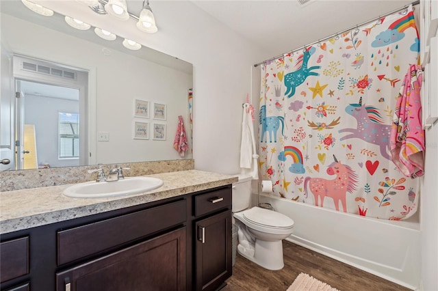 955 Grandin St, Davenport, FL 33837 - bathroom featuring vanity, toilet, wood finished floors, and shower / bath combo