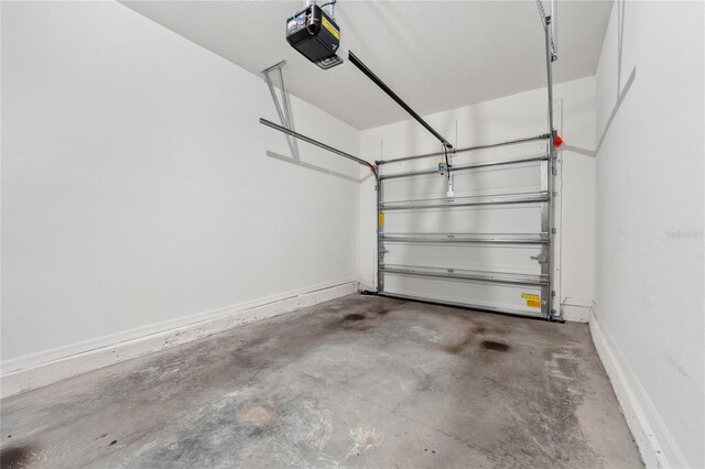 955 Grandin St, Davenport, FL 33837 - garage featuring a garage door opener and baseboards