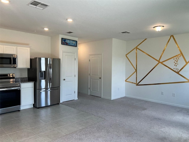254 Mandovi St, Davenport, FL 33837 - kitchen featuring stainless steel appliances, white cabinets, light carpet, recessed lighting, and baseboards