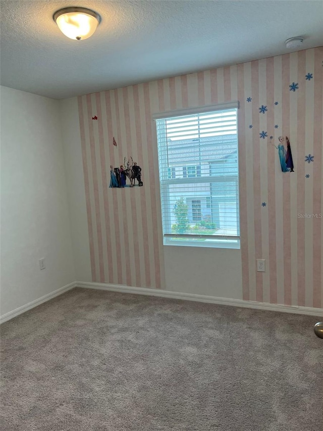 254 Mandovi St, Davenport, FL 33837 - empty room with a textured ceiling, carpet flooring, a smoke detector, and baseboards