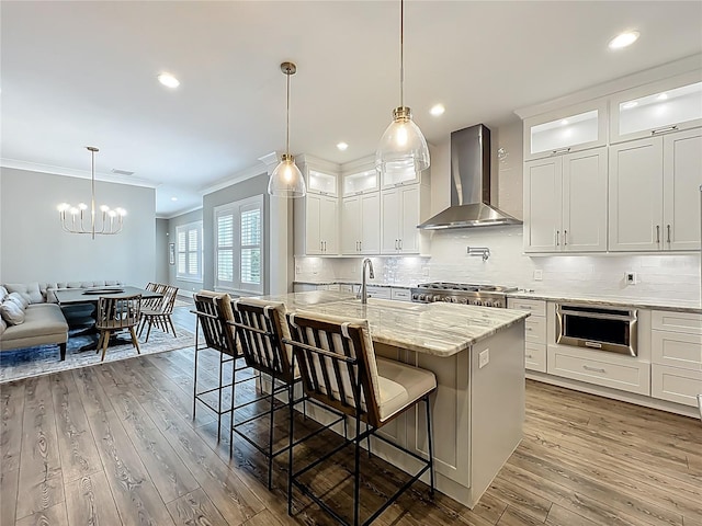 960 Civitas Way, Winter Garden, FL 34787 - kitchen with wall chimney range hood, ornamental molding, a chandelier, tasteful backsplash, and range