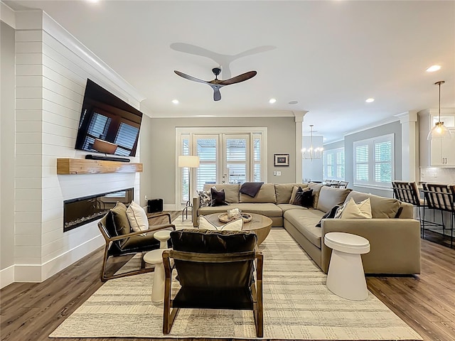 960 Civitas Way, Winter Garden, FL 34787 - living room featuring a fireplace, ceiling fan, light wood-type flooring, ornamental molding, and recessed lighting