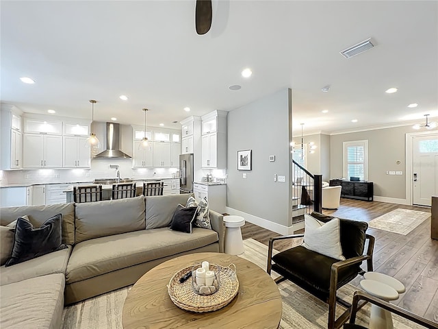 960 Civitas Way, Winter Garden, FL 34787 - living area featuring baseboards, wood finished floors, stairs, crown molding, and recessed lighting