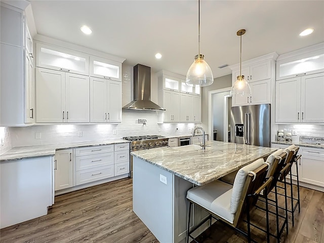 960 Civitas Way, Winter Garden, FL 34787 - kitchen featuring appliances with stainless steel finishes, wall chimney range hood, tasteful backsplash, white cabinetry, and dark wood finished floors