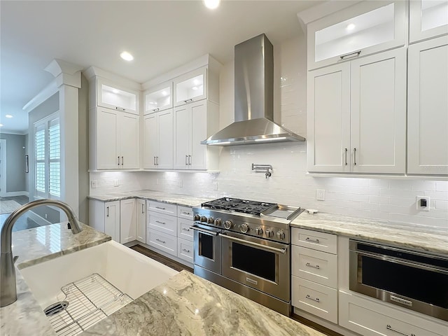 960 Civitas Way, Winter Garden, FL 34787 - kitchen with range with two ovens, wall chimney exhaust hood, a sink, white cabinetry, and recessed lighting