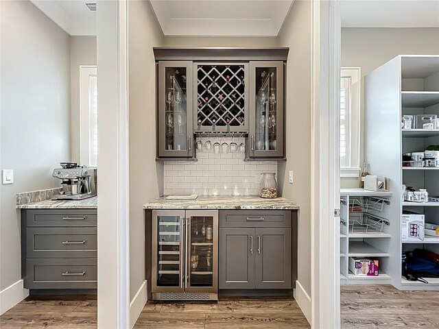 960 Civitas Way, Winter Garden, FL 34787 - indoor dry bar with beverage cooler, backsplash, wood finished floors, and baseboards
