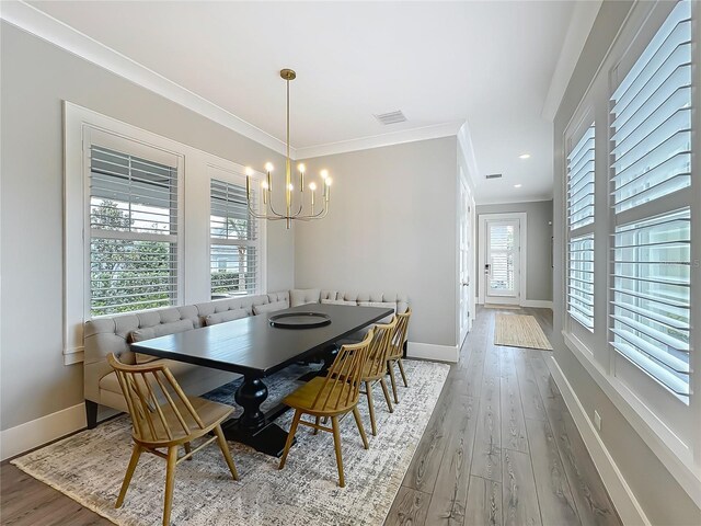 960 Civitas Way, Winter Garden, FL 34787 - dining room featuring a chandelier, baseboards, ornamental molding, wood finished floors, and breakfast area