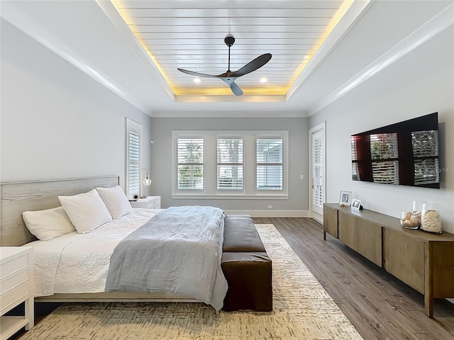 960 Civitas Way, Winter Garden, FL 34787 - bedroom with a tray ceiling, light wood-type flooring, ornamental molding, baseboards, and ceiling fan