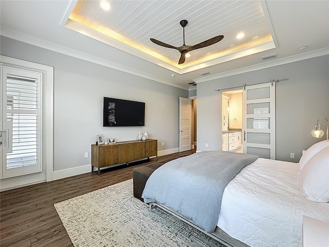 960 Civitas Way, Winter Garden, FL 34787 - bedroom featuring a raised ceiling, dark wood-type flooring, a barn door, baseboards, and recessed lighting