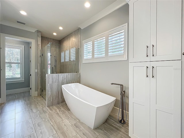 960 Civitas Way, Winter Garden, FL 34787 - full bath with a stall shower, plenty of natural light, a freestanding bath, recessed lighting, and baseboards