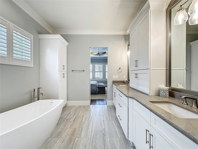 960 Civitas Way, Winter Garden, FL 34787 - ensuite bathroom featuring a soaking tub, double vanity, crown molding, and baseboards