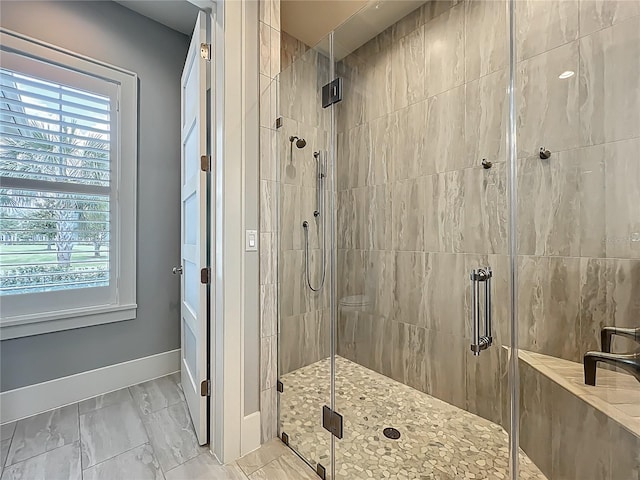 960 Civitas Way, Winter Garden, FL 34787 - bathroom with baseboards, a shower stall, and marble finish floors