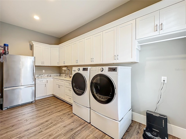 960 Civitas Way, Winter Garden, FL 34787 - laundry room with washer and dryer, light wood finished floors, recessed lighting, and baseboards