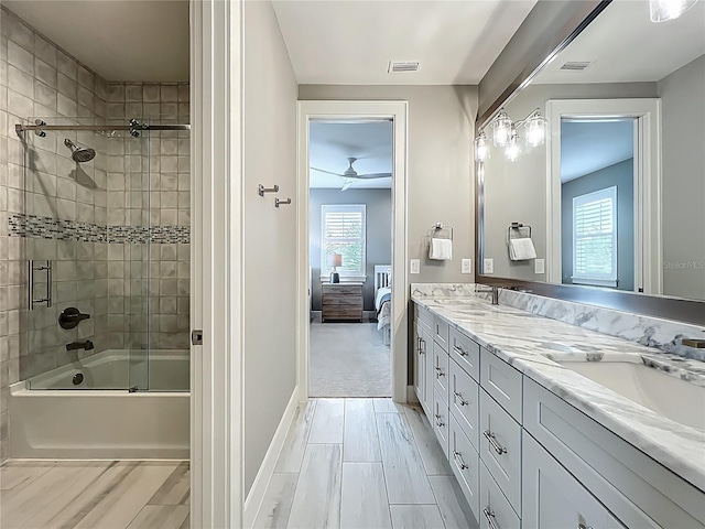 960 Civitas Way, Winter Garden, FL 34787 - bathroom with ensuite bathroom, double vanity, shower / bath combination with glass door, baseboards, and ceiling fan