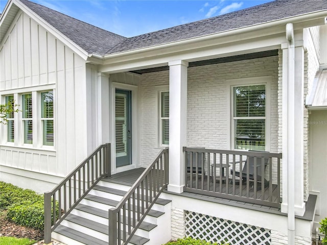 960 Civitas Way, Winter Garden, FL 34787 - doorway to property with covered porch, board and batten siding, roof with shingles, and brick siding
