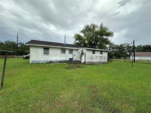 1886 Pleasant Hill Rd, Kissimmee, FL 34746 - rear view of property featuring a yard