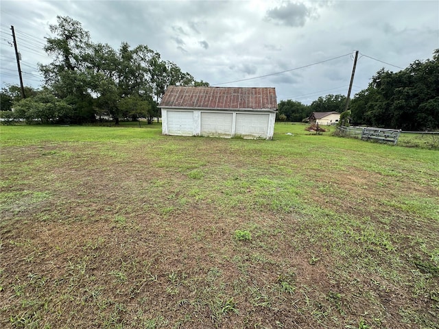 1886 Pleasant Hill Rd, Kissimmee, FL 34746 - view of green lawn featuring a garage and an outbuilding