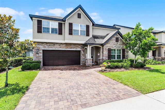 3420 Middlebrook Pl, Harmony, FL 34773 - view of front of house featuring stucco siding, stone siding, decorative driveway, an attached garage, and a front lawn