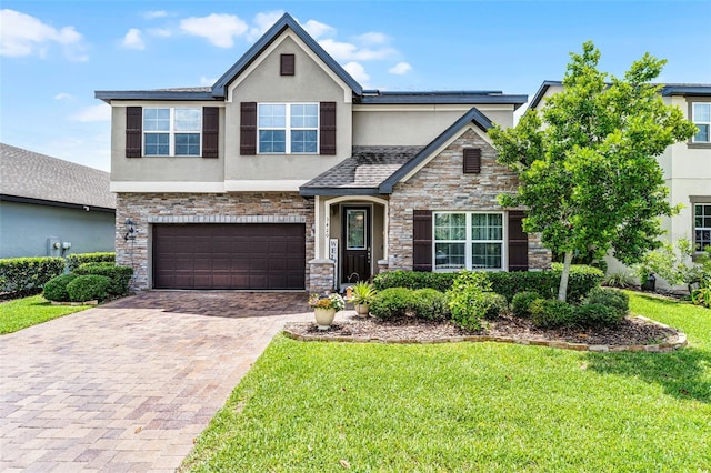 3420 Middlebrook Pl, Harmony, FL 34773 - view of front of property featuring stucco siding, stone siding, decorative driveway, and a garage