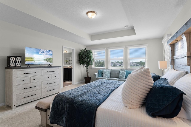 3420 Middlebrook Pl, Harmony, FL 34773 - bedroom with light colored carpet, a tray ceiling, and ensuite bath