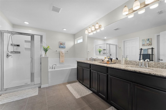 3420 Middlebrook Pl, Harmony, FL 34773 - bathroom with double vanity, a garden tub, a shower stall, tile patterned flooring, and recessed lighting