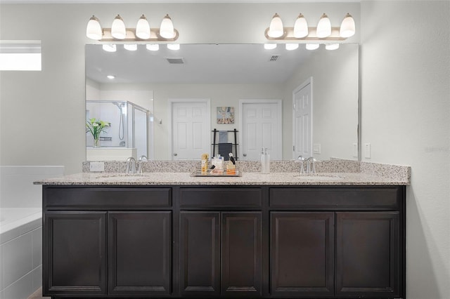 3420 Middlebrook Pl, Harmony, FL 34773 - bathroom with double vanity, a shower stall, and a bath