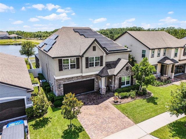3420 Middlebrook Pl, Harmony, FL 34773 - view of front facade with stone siding, stucco siding, decorative driveway, and an attached garage