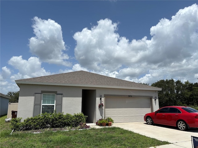 3476 Yarian Dr, Haines City, FL 33844 - view of front of home with stucco siding, a garage, driveway, and a shingled roof