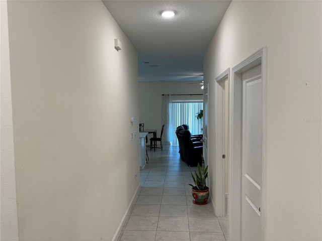3476 Yarian Dr, Haines City, FL 33844 - hallway featuring light tile patterned floors and baseboards
