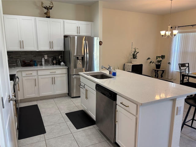 3476 Yarian Dr, Haines City, FL 33844 - kitchen featuring stainless steel appliances, a sink, a chandelier, tasteful backsplash, and light tile patterned floors