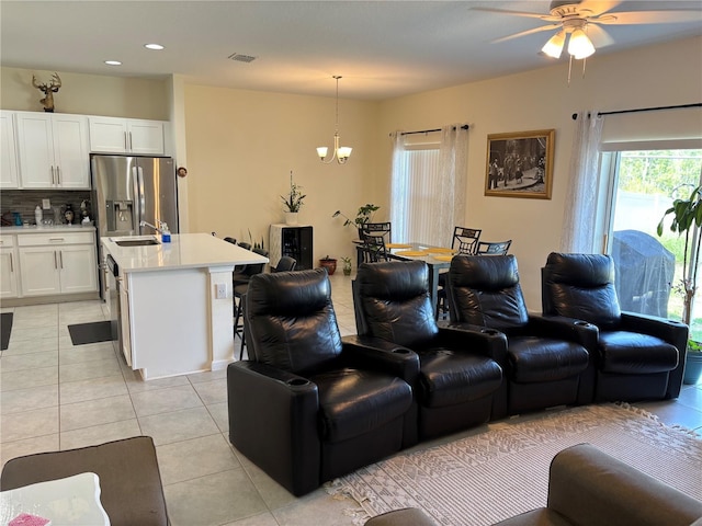 3476 Yarian Dr, Haines City, FL 33844 - living room with light tile patterned floors, ceiling fan, recessed lighting, and a chandelier