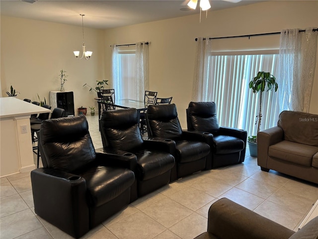 3476 Yarian Dr, Haines City, FL 33844 - living room with light tile patterned floors, ceiling fan, and a chandelier