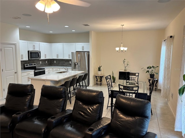 3476 Yarian Dr, Haines City, FL 33844 - kitchen with appliances with stainless steel finishes, a sink, light tile patterned floors, backsplash, and light countertops