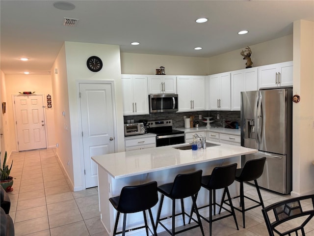 3476 Yarian Dr, Haines City, FL 33844 - kitchen with stainless steel appliances, a sink, light tile patterned flooring, backsplash, and recessed lighting