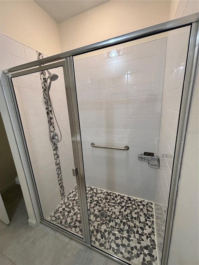 3476 Yarian Dr, Haines City, FL 33844 - bathroom with a stall shower, toilet, and tile patterned flooring