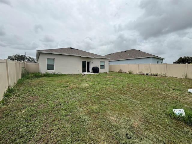 3476 Yarian Dr, Haines City, FL 33844 - rear view of property with stucco siding and a shingled roof