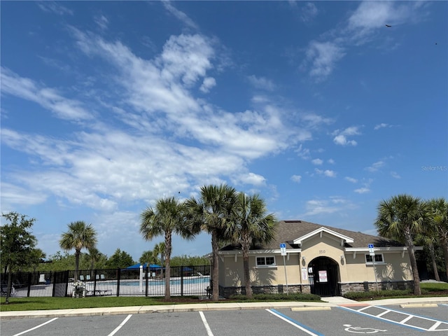 3476 Yarian Dr, Haines City, FL 33844 - view of building exterior with uncovered parking and a community pool