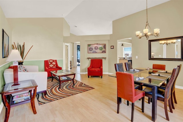 737 Oxford Dr, Davenport, FL 33897 - dining space with wood finished floors, a chandelier, lofted ceiling, and baseboards