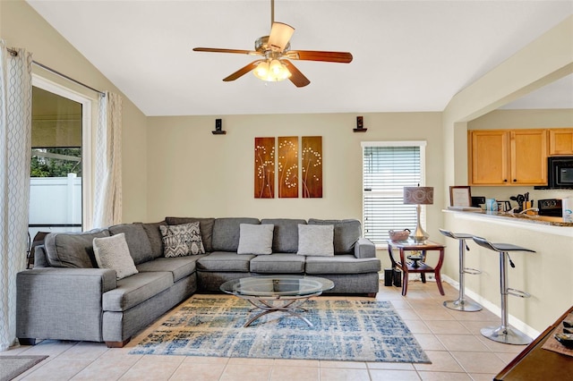 737 Oxford Dr, Davenport, FL 33897 - living area with a ceiling fan, light tile patterned floors, vaulted ceiling, and baseboards