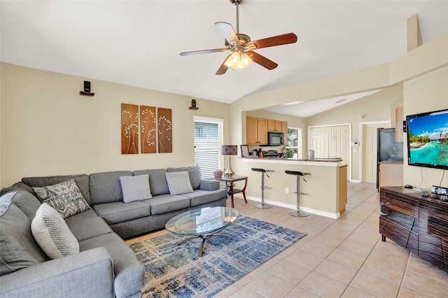 737 Oxford Dr, Davenport, FL 33897 - living room with light tile patterned floors, vaulted ceiling, and a ceiling fan