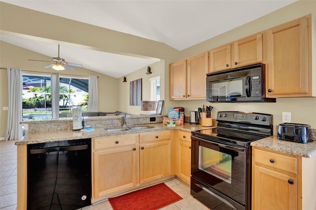 737 Oxford Dr, Davenport, FL 33897 - kitchen with black appliances, light brown cabinets, a sink, a peninsula, and vaulted ceiling