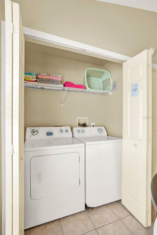737 Oxford Dr, Davenport, FL 33897 - washroom with washing machine and dryer and light tile patterned floors