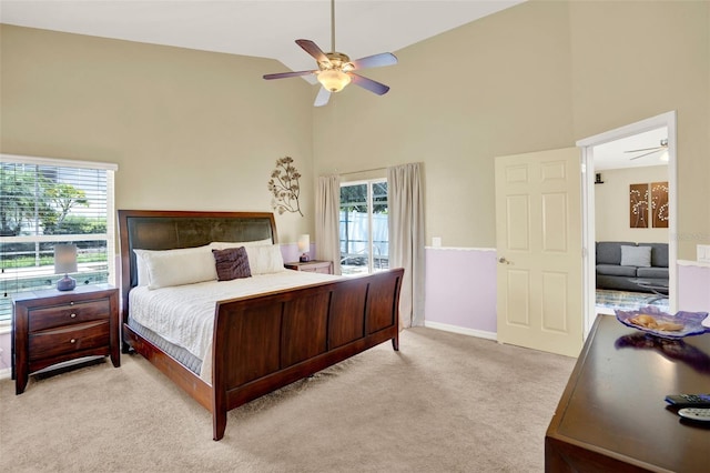737 Oxford Dr, Davenport, FL 33897 - bedroom with high vaulted ceiling, light carpet, access to outside, ceiling fan, and baseboards